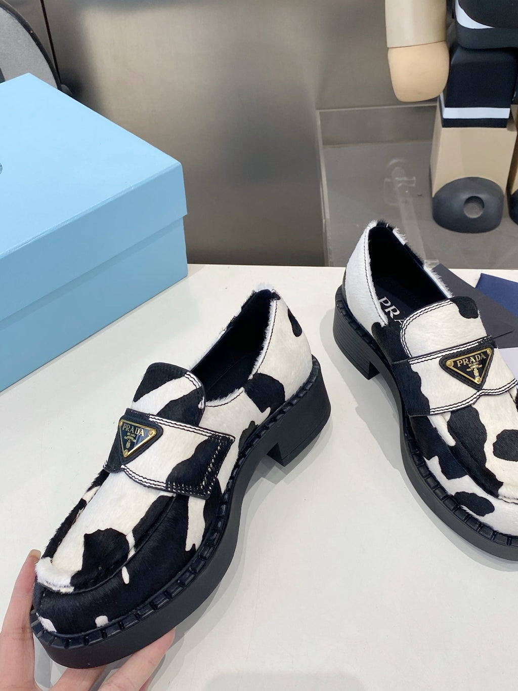 PRADA 26S LOAFERS IN WHITE AND BLACK COW PRINT PONY HAIR