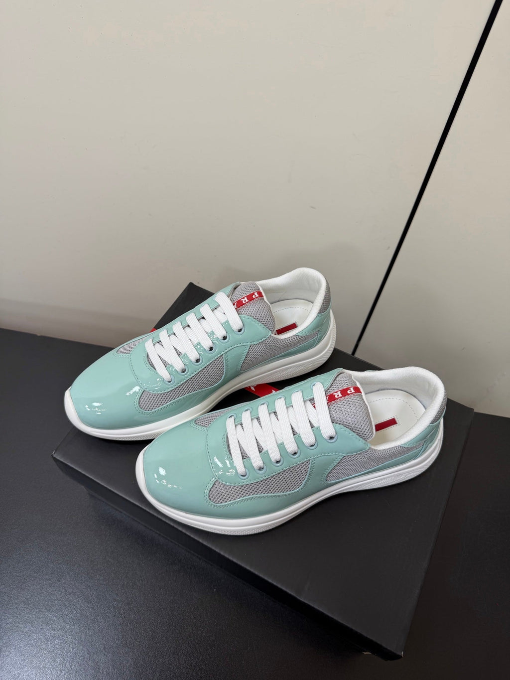 PRADA 26S SNEAKERS IN SOFT TEAL PATENT CALFSKIN AND WHITE MESH