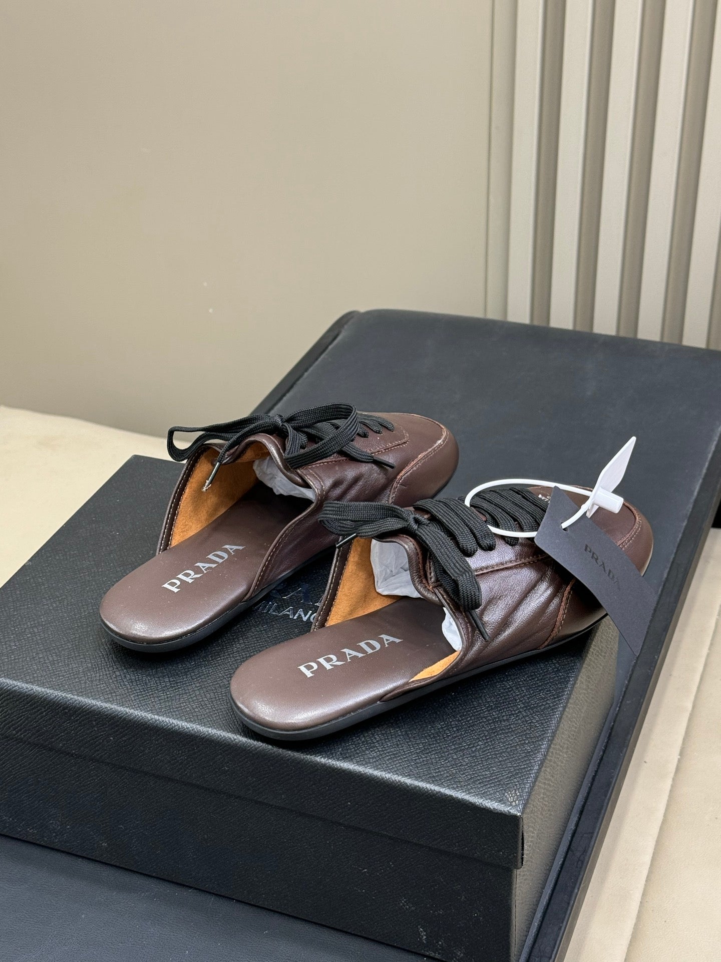 PRADA 25S COLLAPSE MULES IN DARK BROWN CALFSKIN
